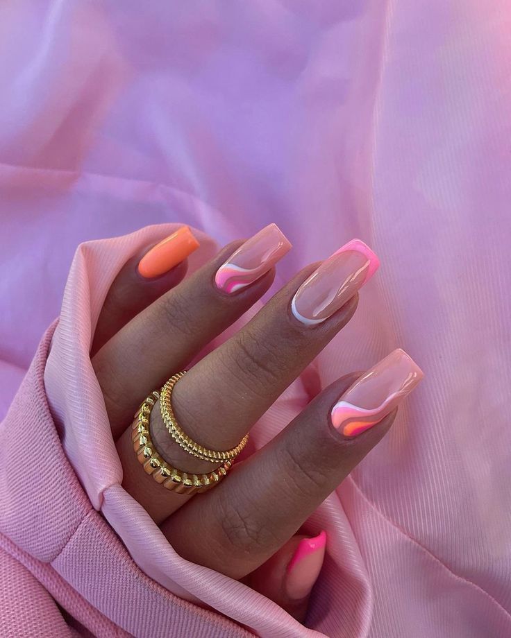 Chic Colorful Nail Design: Soft Pinks and Vibrant Oranges with Creative Swirls and Gold Rings.