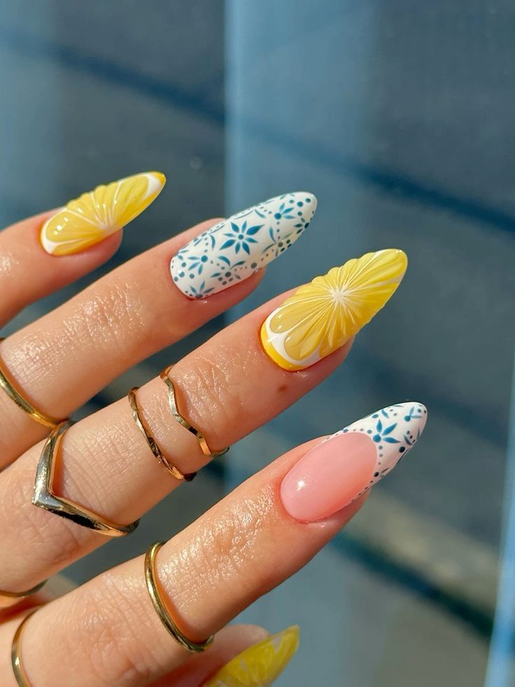 Playful Citrus and Floral Nail Design with Glossy Pink Base and Gold Accents