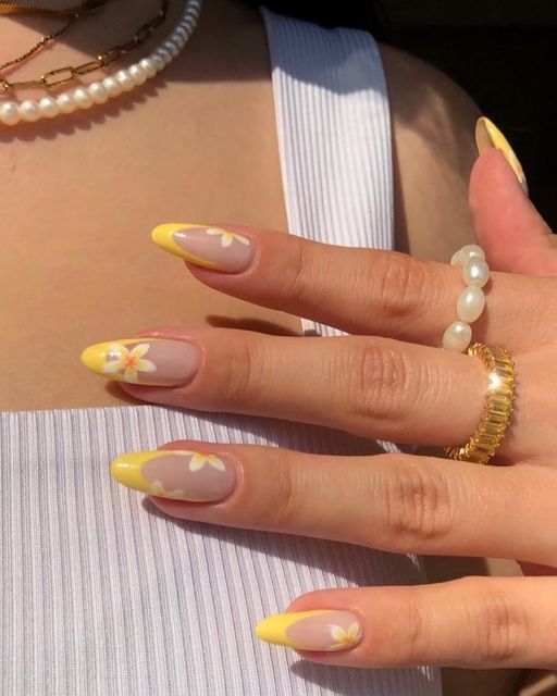 Summery Nail Design: Nude Base with Cheerful Yellow Tips and Whimsical White Florals.