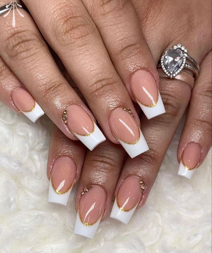 Chic French Tip Nail Design with Nude Base and Gold Accents