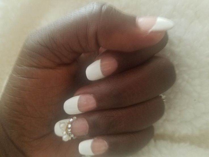 Sophisticated French Manicure with Glamorous Embellishments.