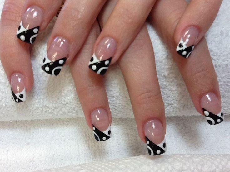 Chic Black and White French Tip Nail Design with Playful Patterns.