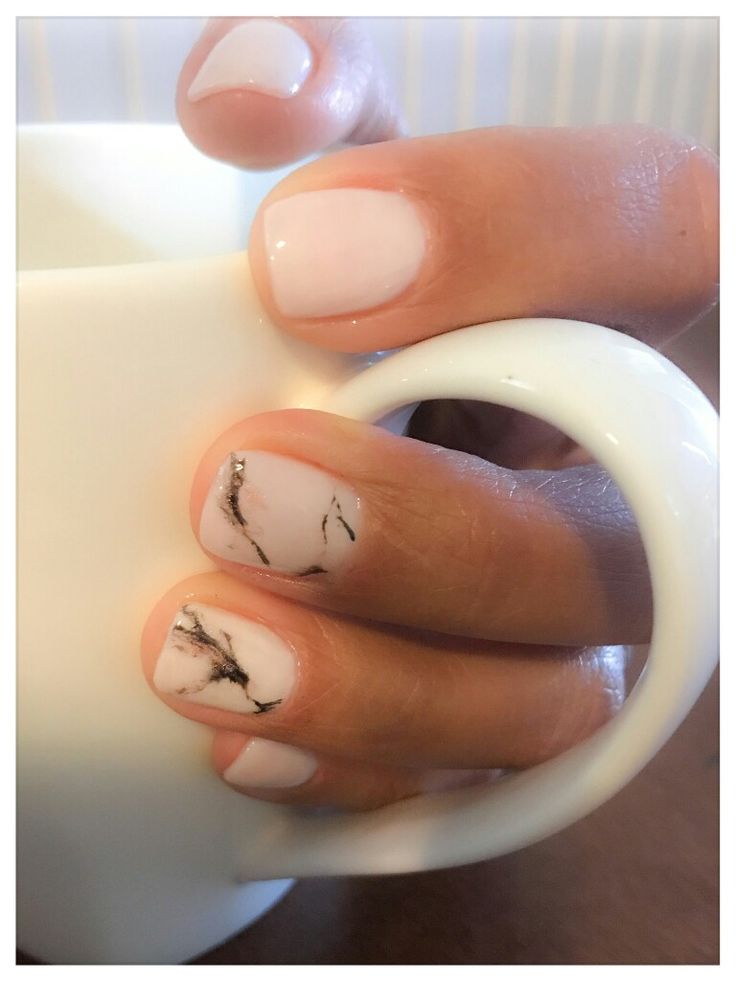 Sophisticated White Base Nail Design with Striking Marble Accents