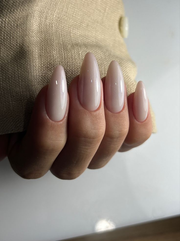 Sophisticated Elegant Almond-Shaped Nails in Soft Nude with High-Gloss Finish.