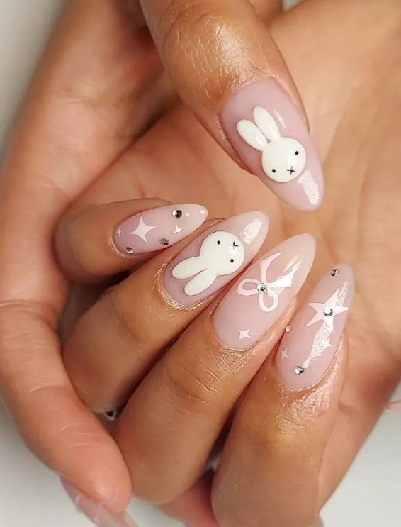 Charming Bunny-Inspired Nail Design with Whimsical Accents on Soft Pink Backgrounds.