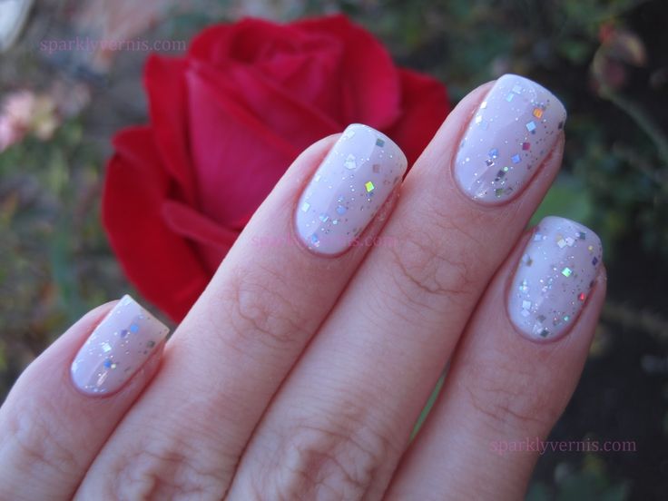 Elegant Nude Nail Design with Iridescent Glitter for a Captivating Shimmer.