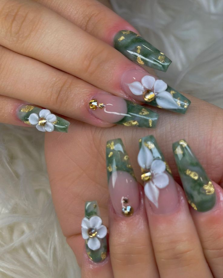 Sophisticated Nail Design: Rich Green Tones with Floral Motifs and Gold Accents.