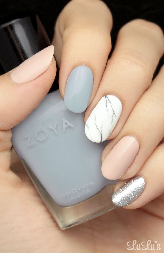 Chic Pastel Nail Design with Marble Accent and Metallic Touch.