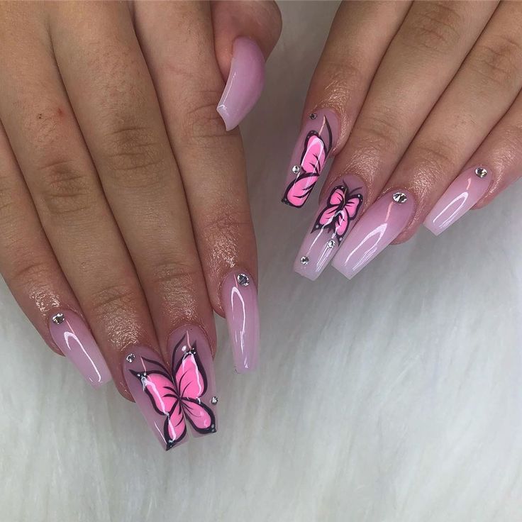 Elegant Soft Pink Nail Design with Intricate Butterfly Art and Sparkling Rhinestones.