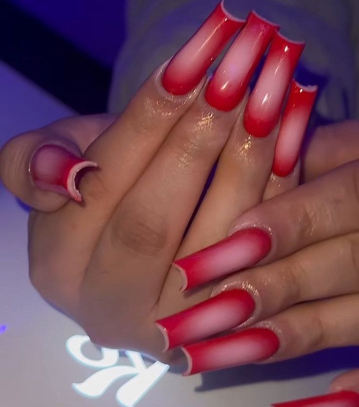 Vibrant Red and White Ombre Nail Design with Artistic Crescent Accents.