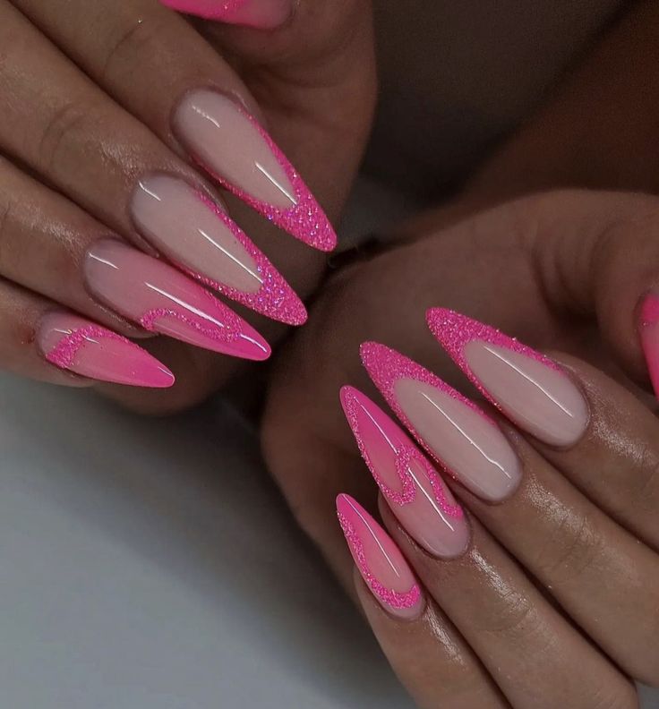 Bold Almond-Shaped Nails in Nude and Vibrant Pink with Glittery Tips and Playful Waves.