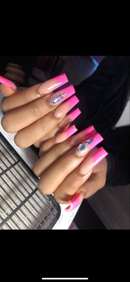 Bold Stiletto Nail Design: Pink Gradient with Dazzling Crystal Accents.