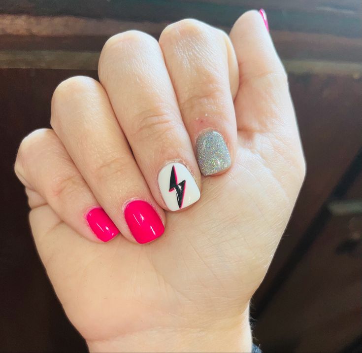 Bold Pink Nail Design with Glittery Accent and Playful Lightning Bolt Detail.