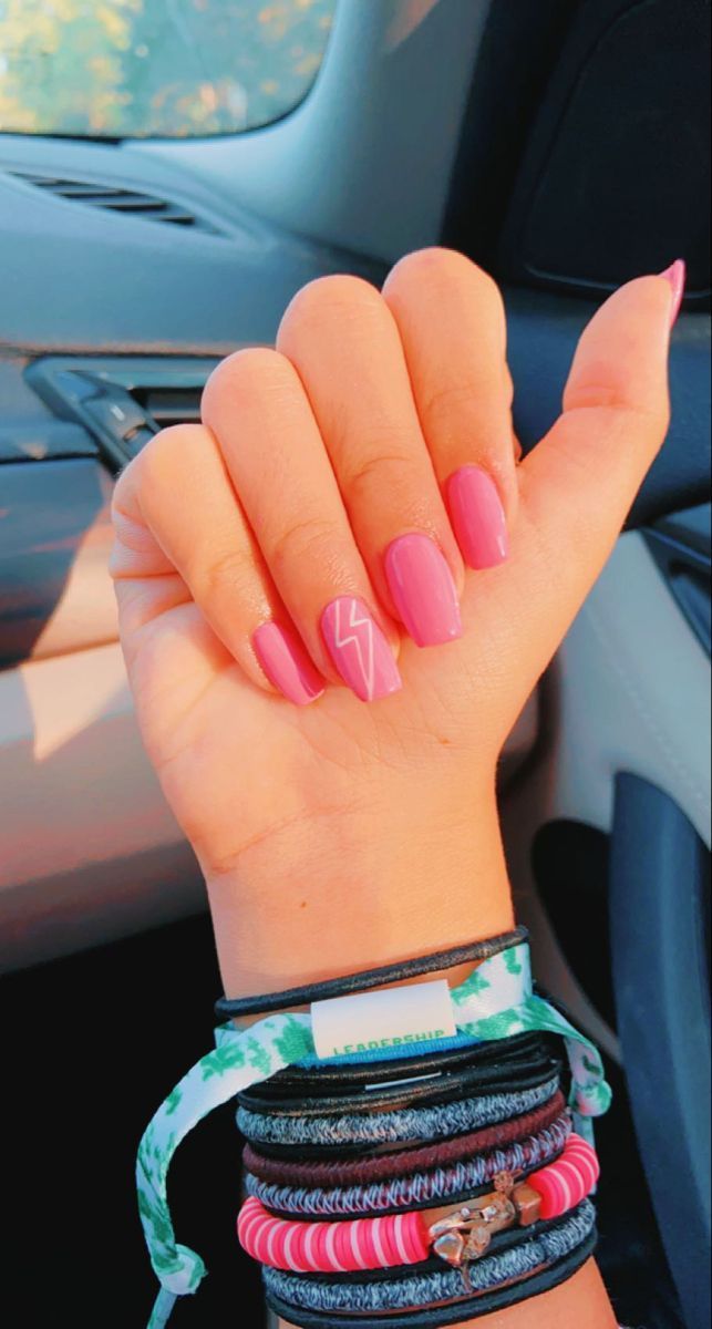 Playful Pink Nails with Lightning Bolt Accent for a Vibrant, Youthful Look