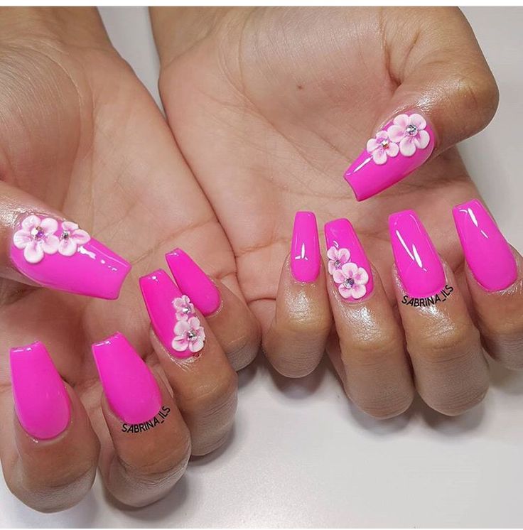 Playful Pink Nail Design with Floral Embellishments for Spring/Summer.