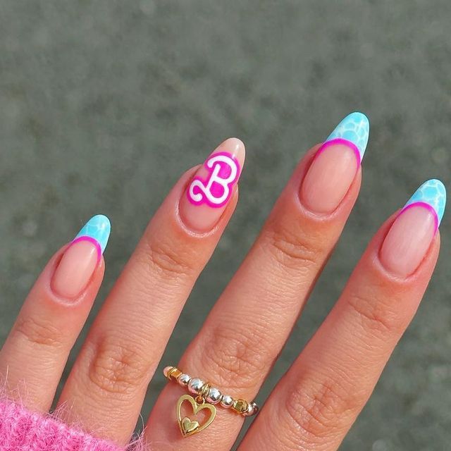 Vibrant Almond-Shaped Nails with Playful Design and Unique Embellishment.