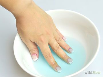 Elegant Gradient French Manicure: A Relaxing Nail Care Ritual in Colored Water.