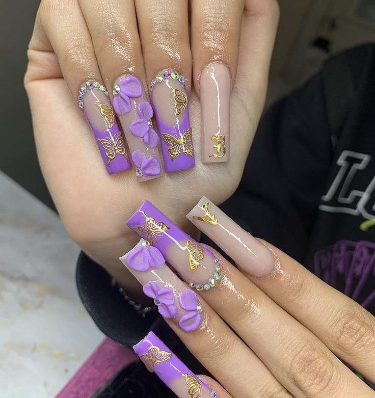 Elegant Purple Nail Design with Floral Accents and Rhinestone Details.