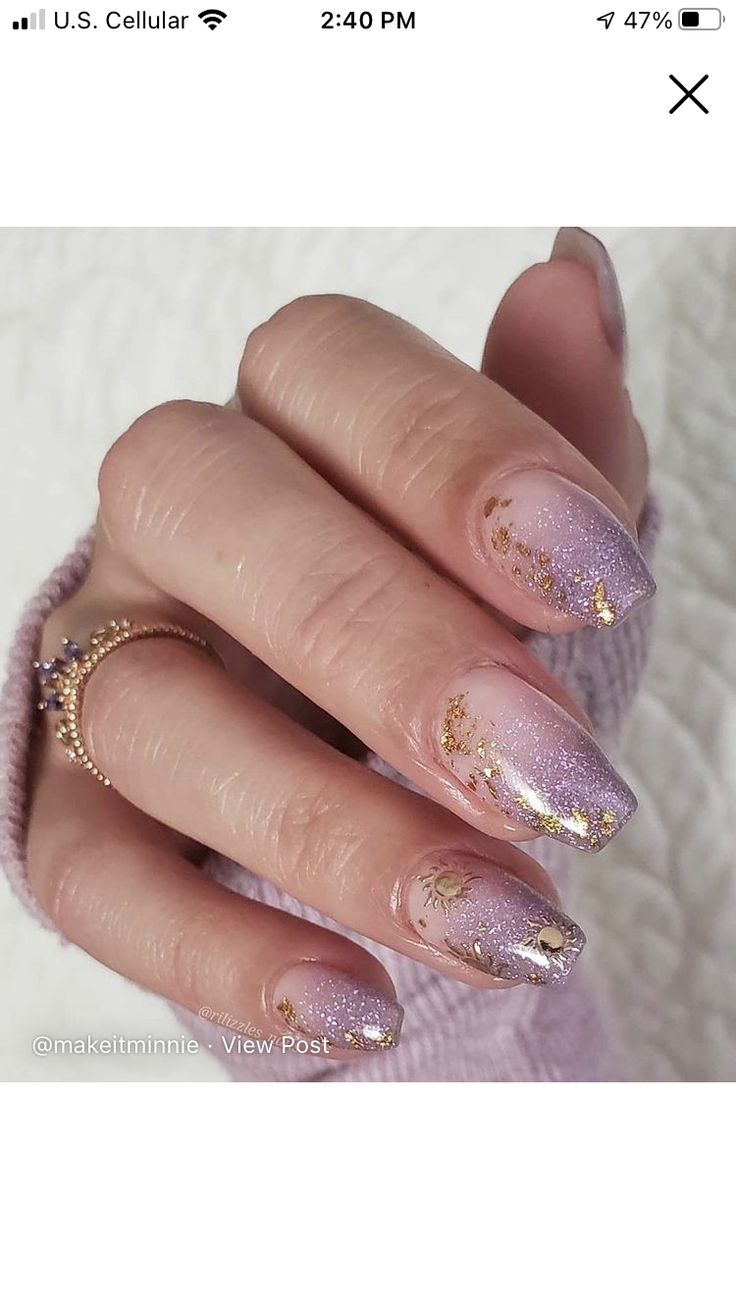 Chic Gradient Nail Design: Soft Lavender to Sparkling Pastel Pink with Glittery Gold Accents and Celestial Motifs.