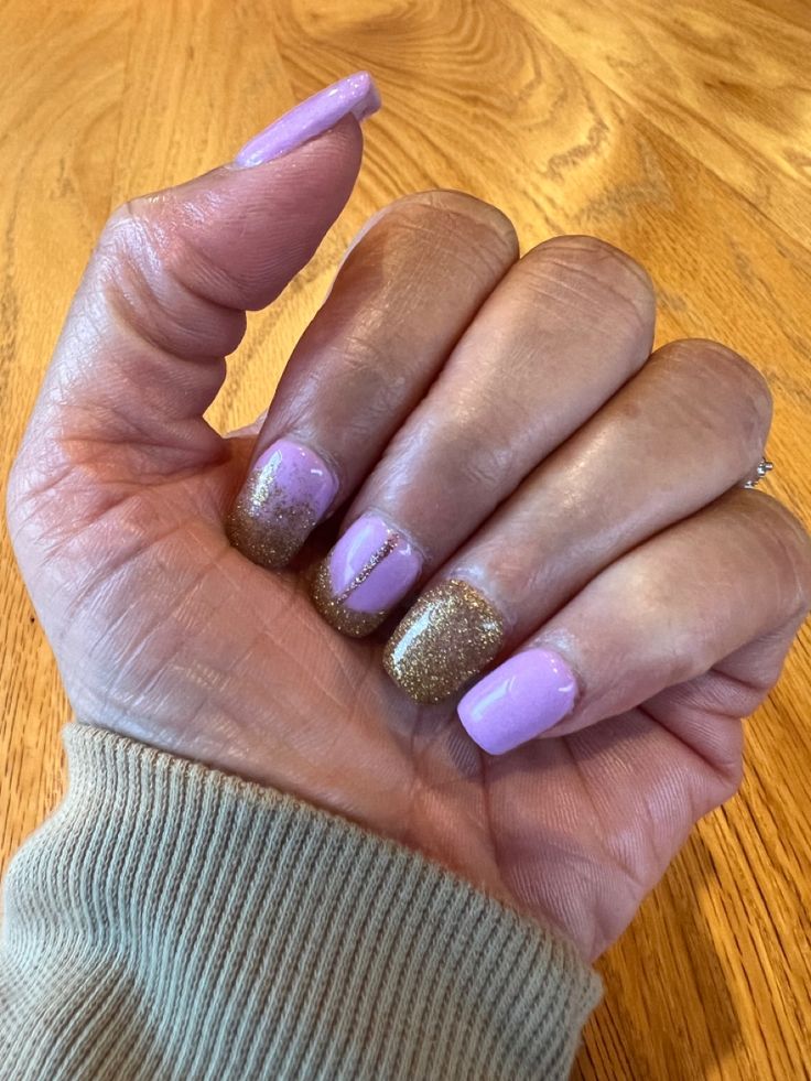 Chic Pastel Purple and Sparkling Gold Nail Design with Elegant Accents.