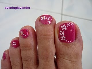 Playful Summer Pink Toenail Design with Elegant White Floral Accents.