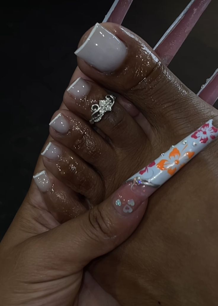 Elegant Nude Acrylic Nail Design with Floral Accent and Complementary Pedicure.