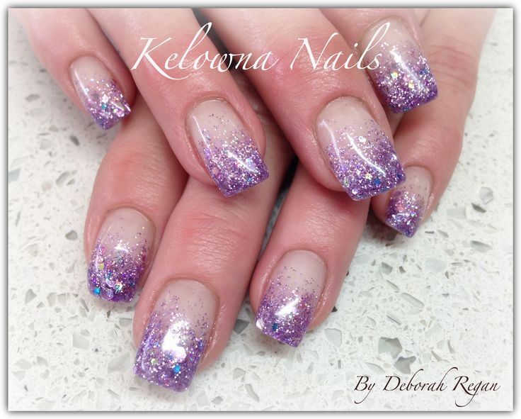 Elegant Gradient Nail Design: Nude Base to Sparkling Purple with Glitter Tips.