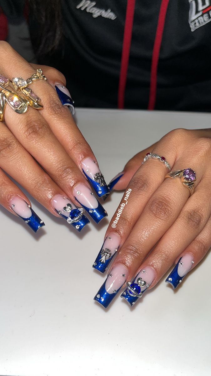 Elegant Deep Blue and Nude Nail Design with Sparkling Accents.