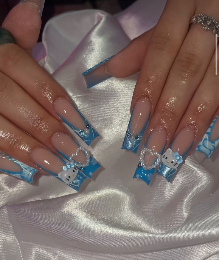 Whimsical Blue and Clear Gel Nail Design with Cloud Motifs and Gem Accents.