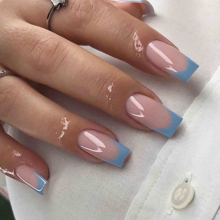 Chic Nude Base with Striking Sky-Blue French Tips: A Modern Nail Design Twist.