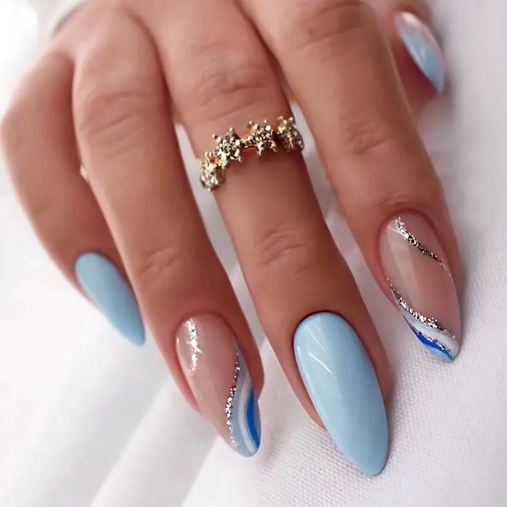 Chic Blue Nail Design with Elegant Accents and Glamorous Ring Detail.