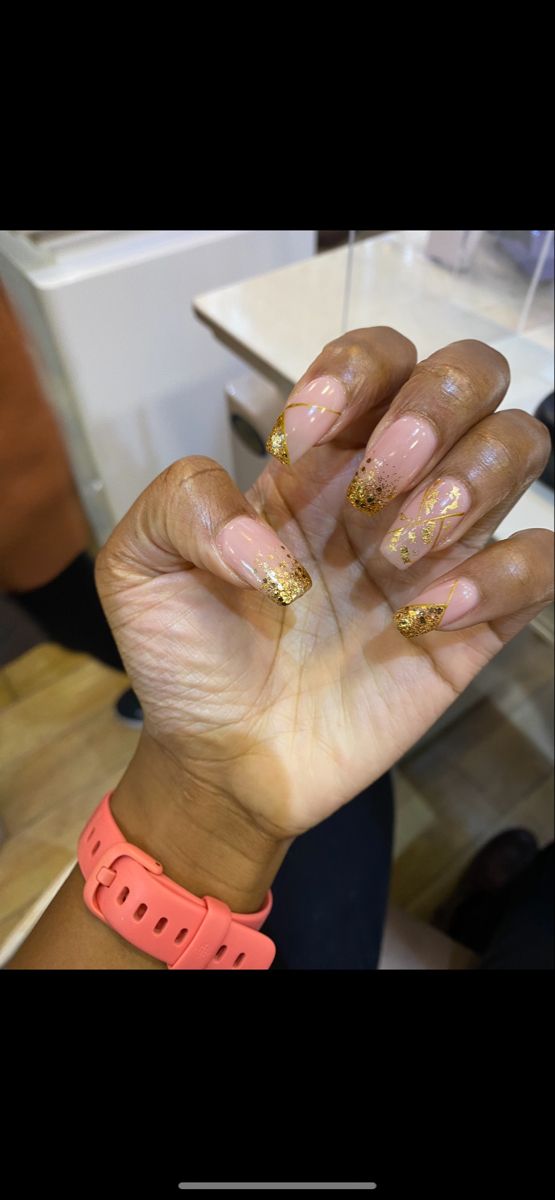 Sophisticated Nude Base Nail Design with Shimmering Gold Glitter Tips for Any Occasion.