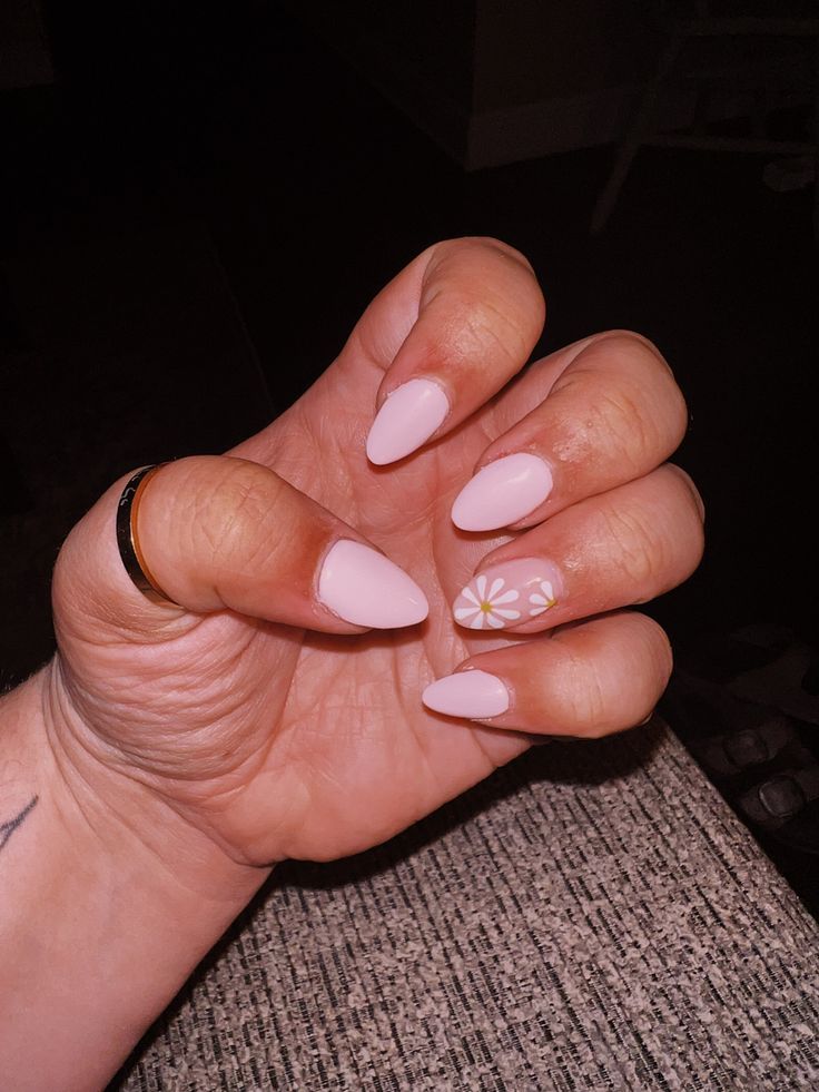 Chic Pastel Pink Almond Nails with Delicate Floral Accents for Year-Round Elegance.