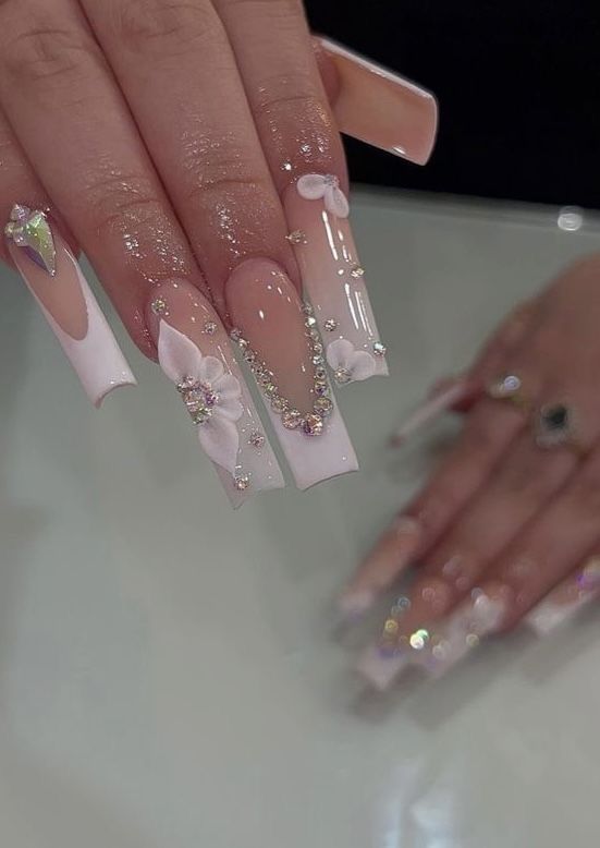 Sophisticated Nail Design: Soft Pink and Clear Varnish with Floral Embellishments and Shimmering Gems