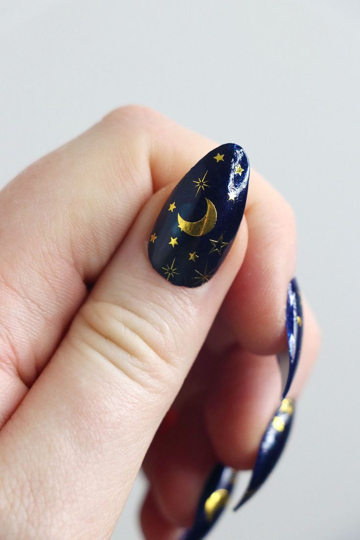 Enchanting Celestial Nail Design: Deep Navy Base with Shimmering Gold Stars and Crescent Moon.