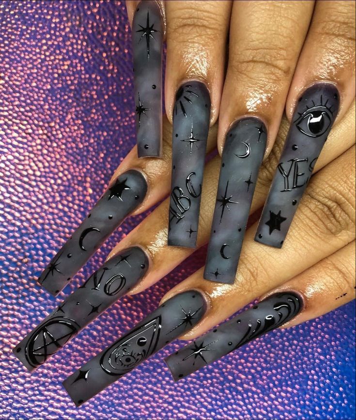 Mysterious Matte Black Nail Design with Celestial Carvings for Bold Self-Expression.