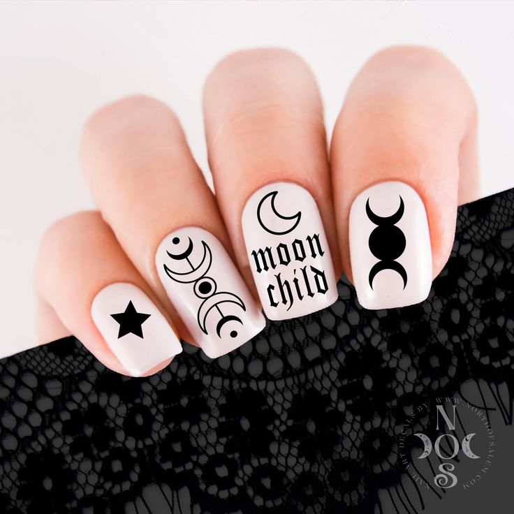 Ethereal Celestial Nail Design: Soft White Base with Black Moons, Stars, and Lunar Phases.