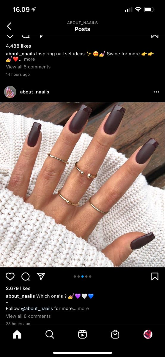 Chic Almond-Shaped Nails in Matte Chocolate Brown Paired with Silver Rings for a Cozy, Sophisticated Look.