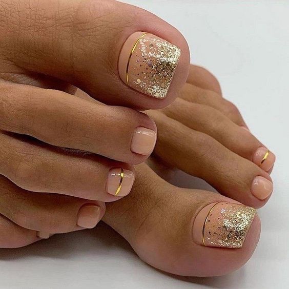 Chic Nude Pedicure with Gold Accents and Sparkling Glitter Finish.