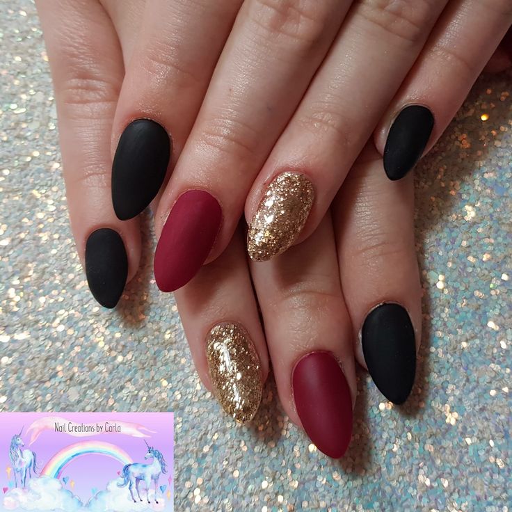 Sophisticated Almond-Shaped Nail Design in Matte Black, Deep Red, and Gold Glitter.