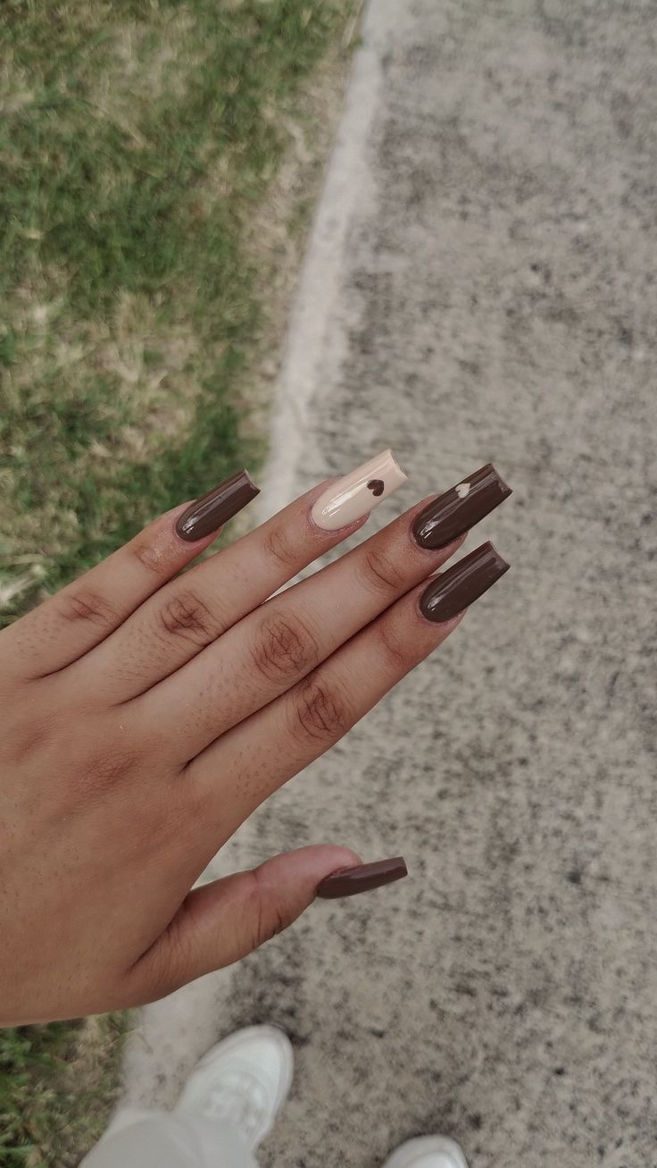 Sophisticated Nail Design with Deep Brown, Nude Tones, and Playful Heart Accent.