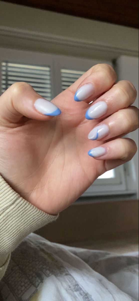 Elegant Translucent Nail Design with Blue Tips and Unique Ombre Accent.