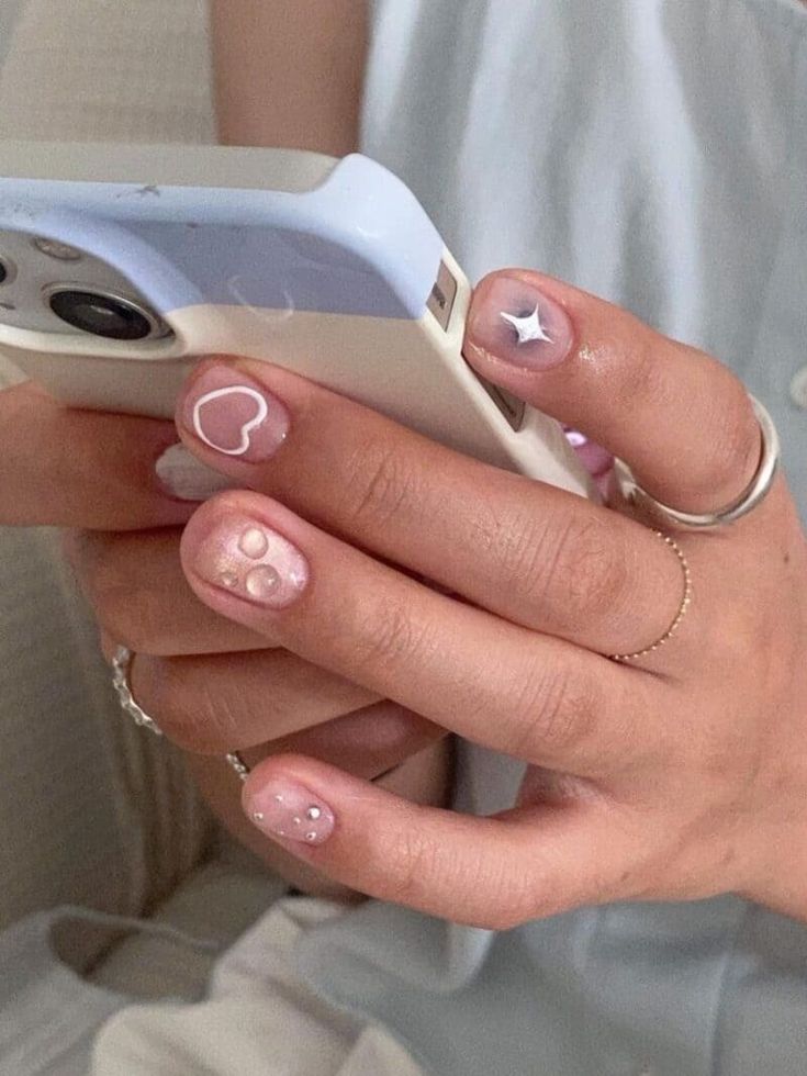 Whimsical Pastel Nail Design with Playful Shapes and Accents