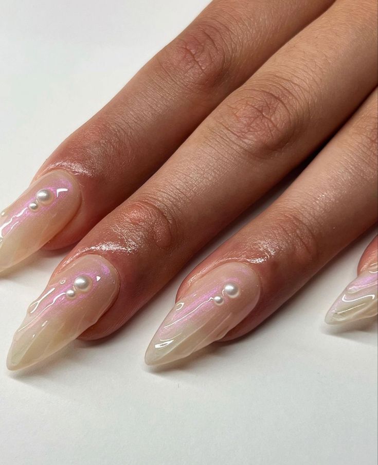 Sophisticated Iridescent Nail Design with Pearlescent Finish and Pearl Embellishments.