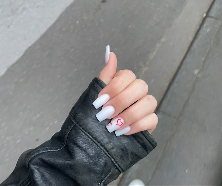 Chic Minimalist Long White Nails with Playful Red Heart Accent