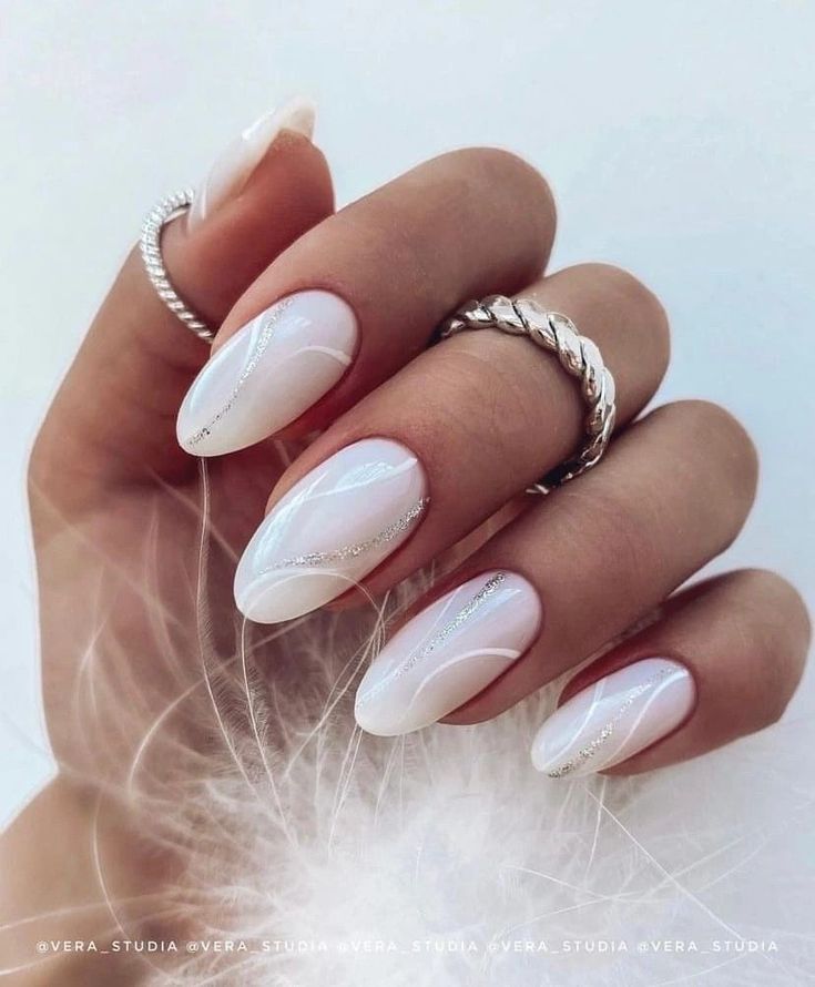 Chic Elegant Nail Design with Soft White Base and Subtle Glass Accents.