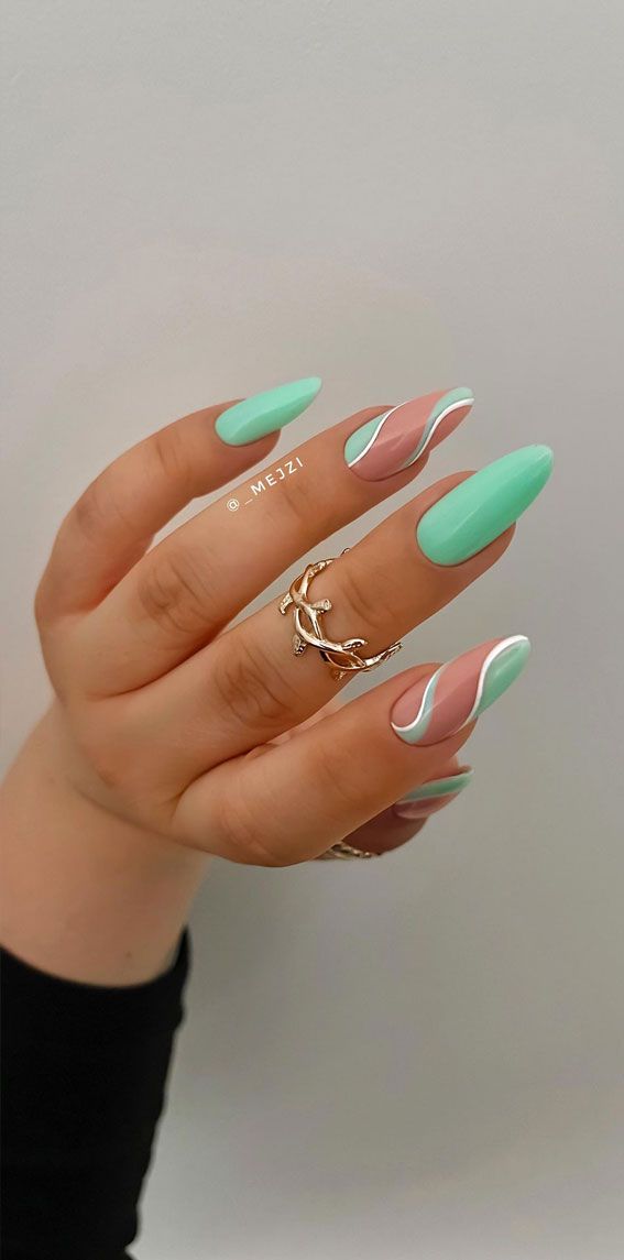 Chic Mint Green and Soft Pink Almond Nail Design with Elegant Accents.