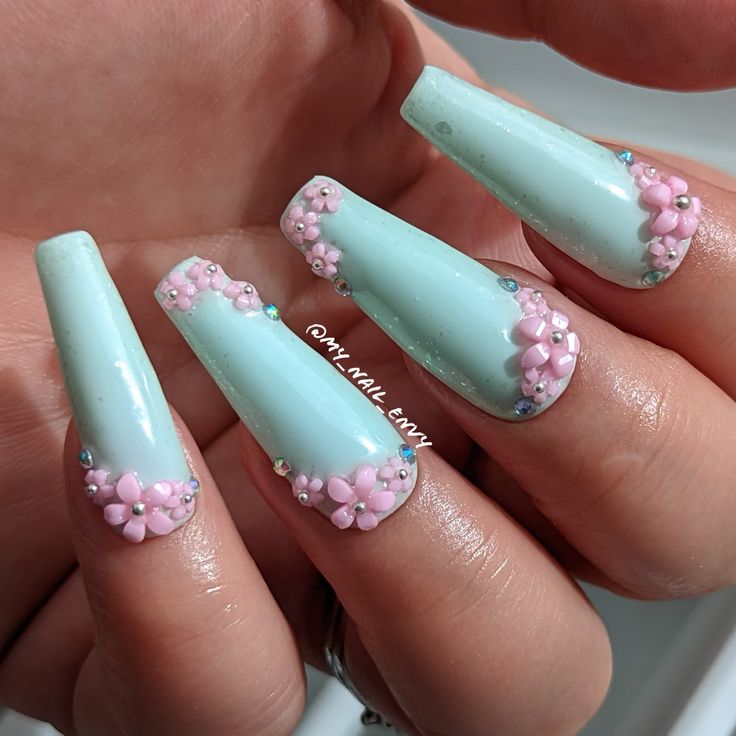 Charming Mint Green Nails with Pink Floral Accents and Sparkling Rhinestones for Spring.