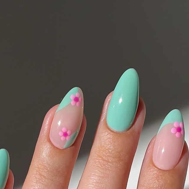 Charming Pastel Floral Nail Design with Glossy Finishes and Triangular Patterns.