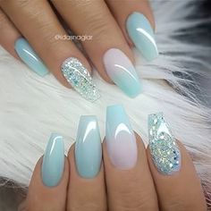 Chic Soft Blue Nail Design with Glossy Finishes and Intricate Accents